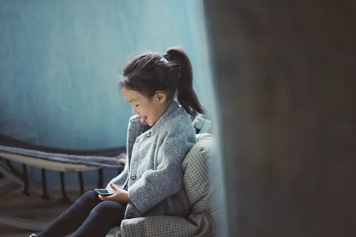 Child using a smartphone at close viewing distance